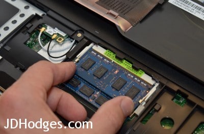 Gently press down on the memory until the retention clips click/lock into place
