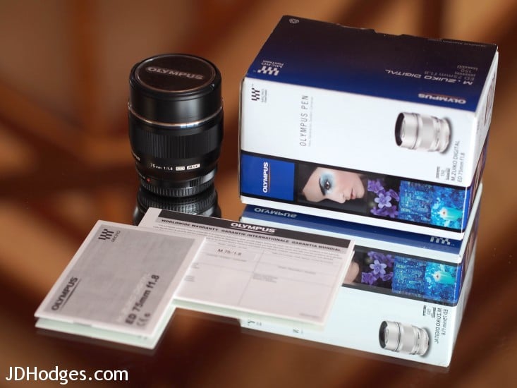 Olympus 75mm lens, box, warranty card, manual