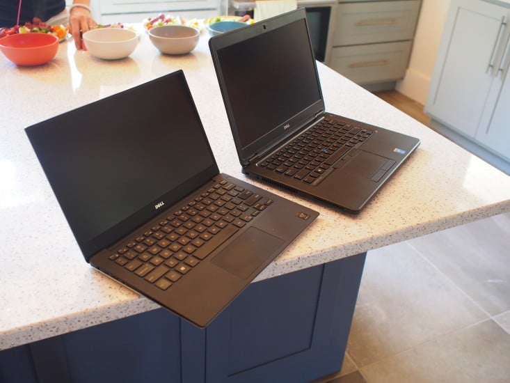 Both laptops are sleek in black
