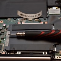 Screwdriver tip pointing to where the ASUS SATA connector is