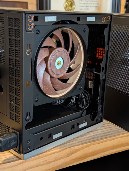 Gigabyte AORUS RTX 5090 AI BOX external GPU enclosure on desk with single Thunderbolt cable connected