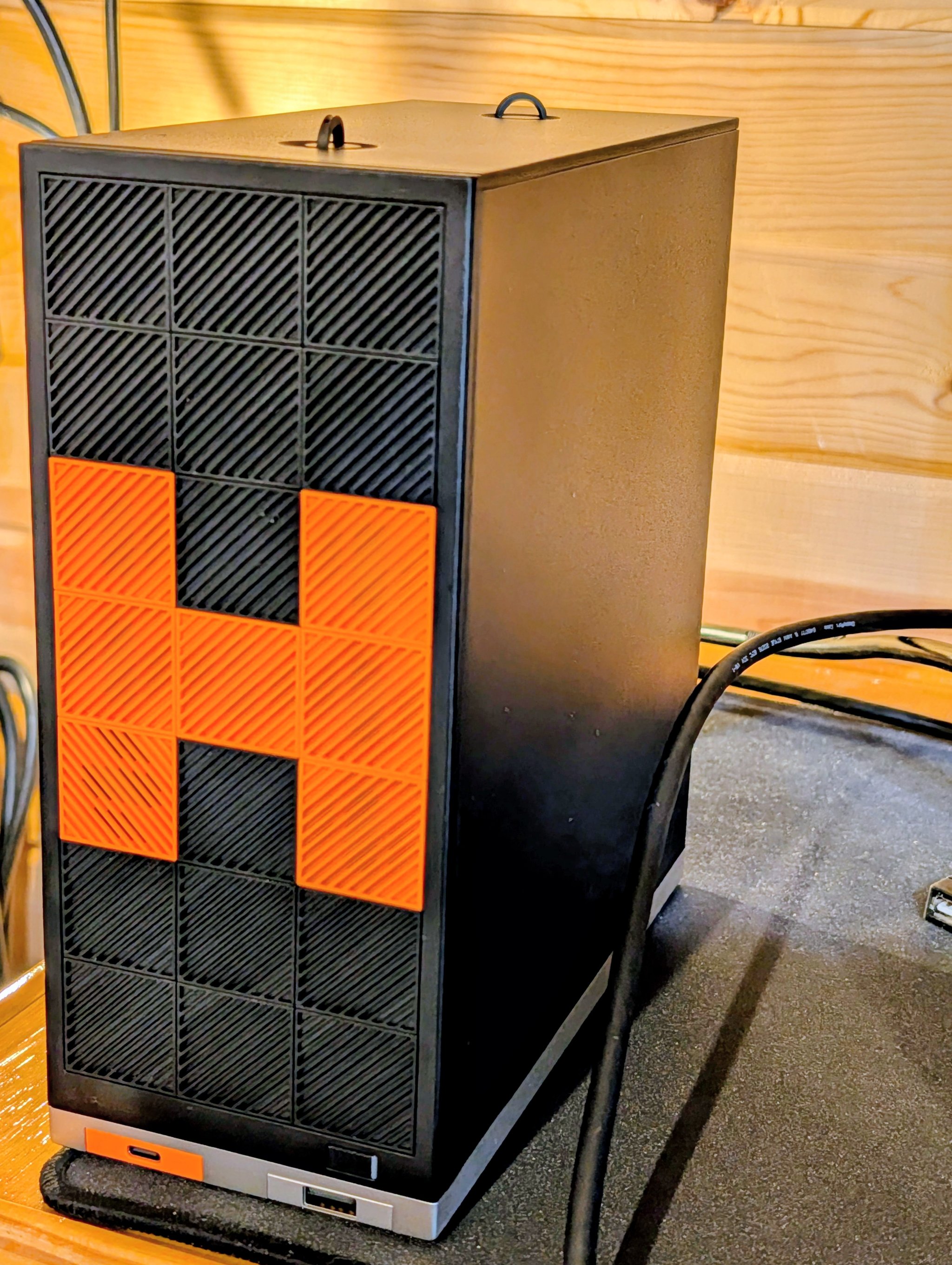 Framework Desktop with AMD Ryzen AI Max+ 395 showing the distinctive orange H logo on the front panel