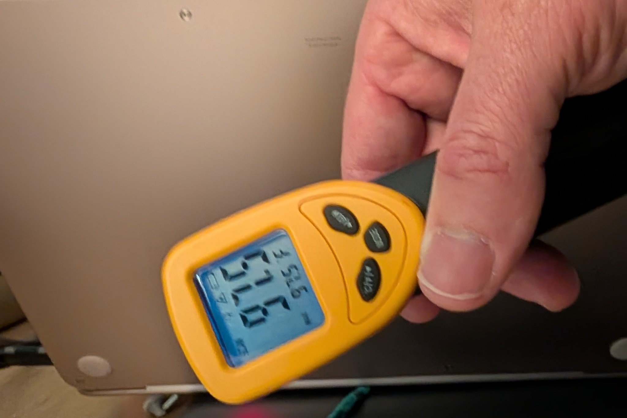 IR thermometer reading 97.6F on MacBook Neo chassis