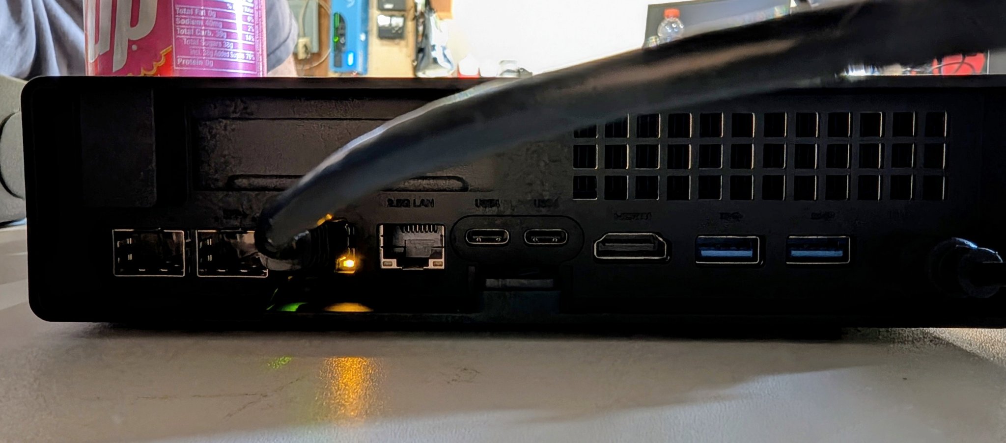 Rear I/O of the Minisforum MS-01 showing dual 10GbE SFP plus ports, dual 2.5GbE Ethernet, USB4, and HDMI