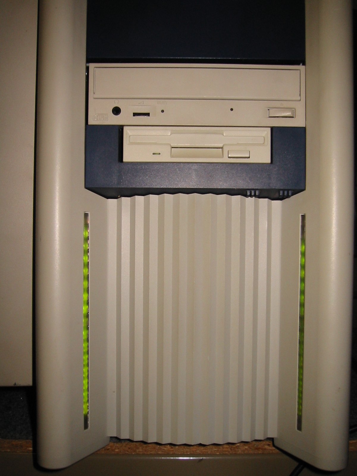 BeBox front close-up showing the two vertical columns of green LED Blinkenlights through the slatted vent grille, with CD-ROM and 3.5-inch floppy bays visible above