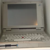 IBM ThinkPad 720C (1993) in the IBM-Beige color variant, open clamshell view, with the red TrackPoint visible between the keys.