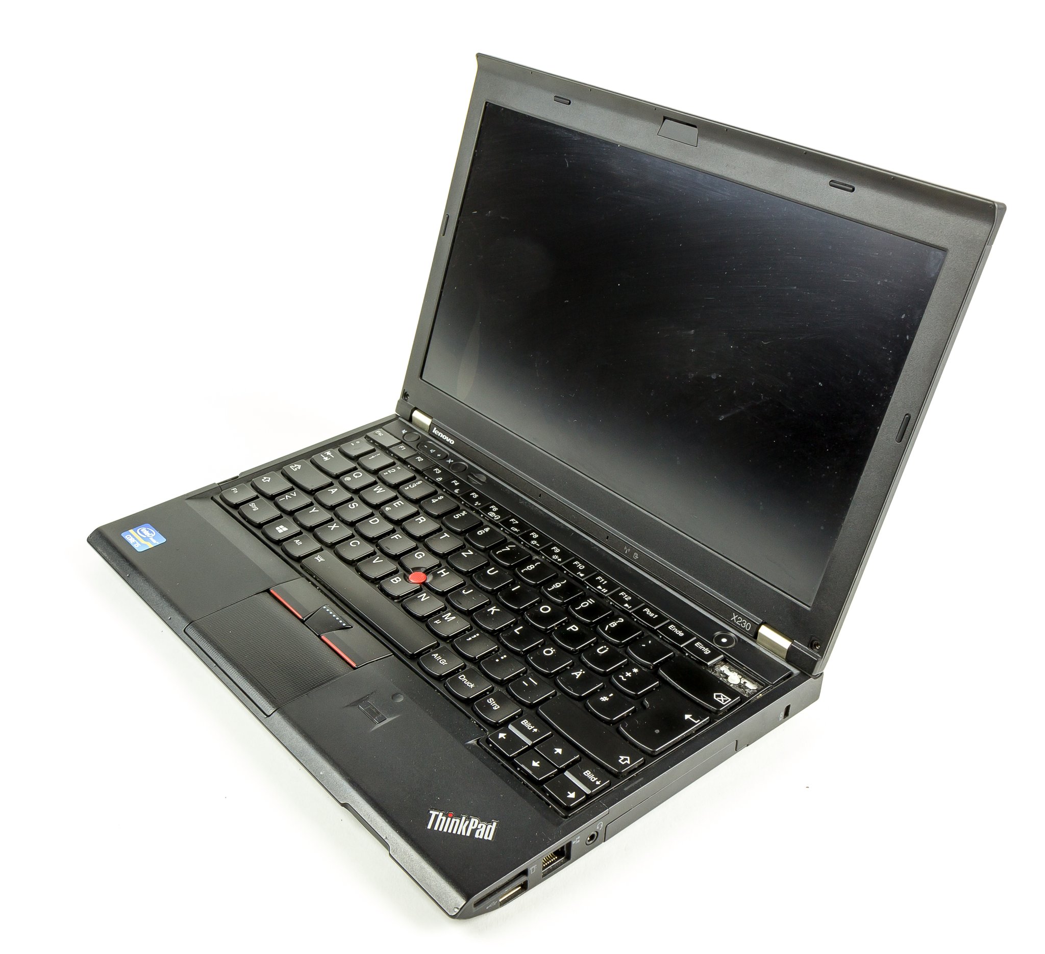 Lenovo ThinkPad X230 12.5-inch ultraportable, 3/4 view with lid open showing the matte-black palm rest, red TrackPoint, and 6-row Precision Keyboard. ThinkPad badge visible at bottom right.